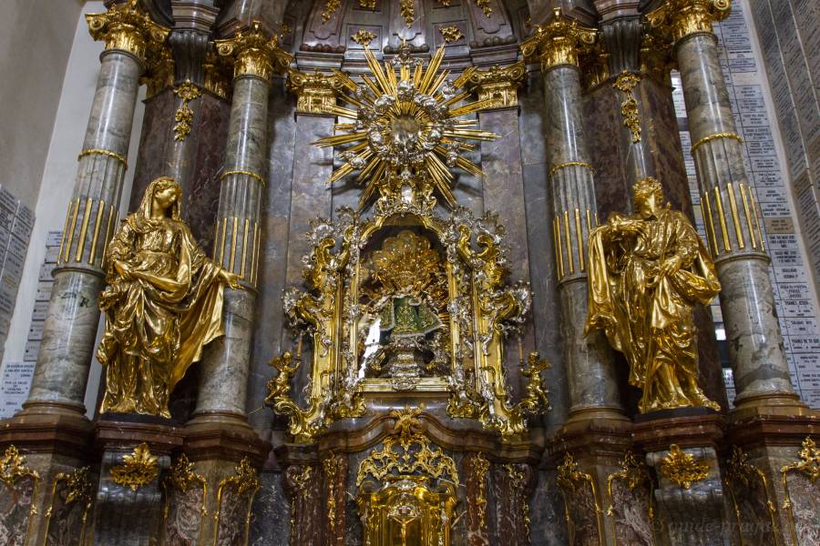 Close-up of the gilded altar inside the Church of Our Lady Victorious in Prague, featuring the iconic statue of the Infant Jesus of Prague.